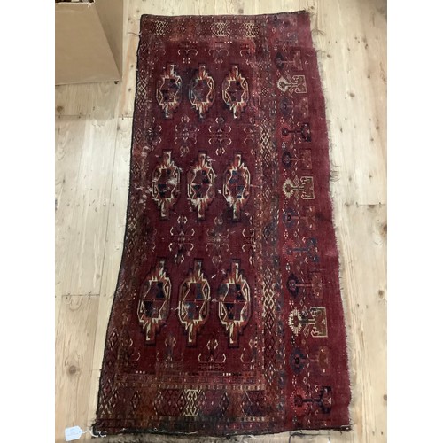 460 - A Middle Eastern flat weave rug having medallions on a wine field 149cm x 68cm and a wool rug with b... 