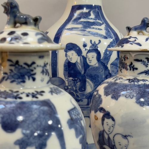 85 - A pair of Chinese blue and white vases of baluster form having associated covers the bodies painted ... 