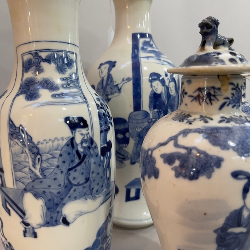 85 - A pair of Chinese blue and white vases of baluster form having associated covers the bodies painted ... 