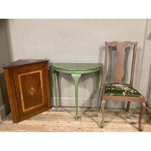 153 - An inlaid hanging corner cupboard, a D shaped green table, a chair with green upholstery