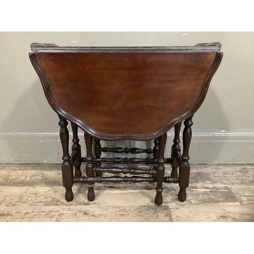 455 - A mahogany drop leaf gateleg table with dished pie crust top