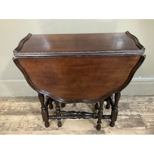 455 - A mahogany drop leaf gateleg table with dished pie crust top