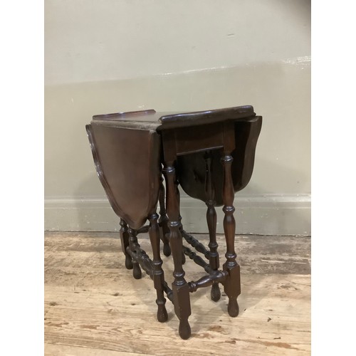 455 - A mahogany drop leaf gateleg table with dished pie crust top