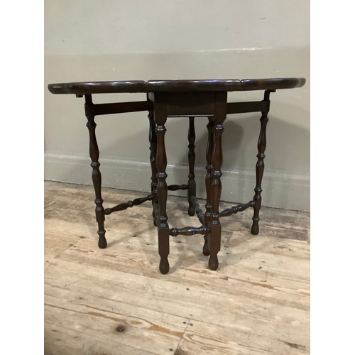 455 - A mahogany drop leaf gateleg table with dished pie crust top