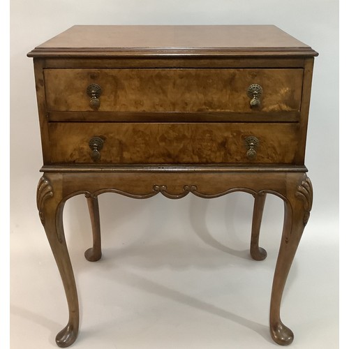 432 - A reproduction figured walnut two drawer side table on cabriole legs, 63cm wide