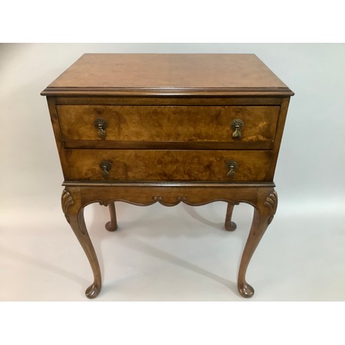 432 - A reproduction figured walnut two drawer side table on cabriole legs, 63cm wide