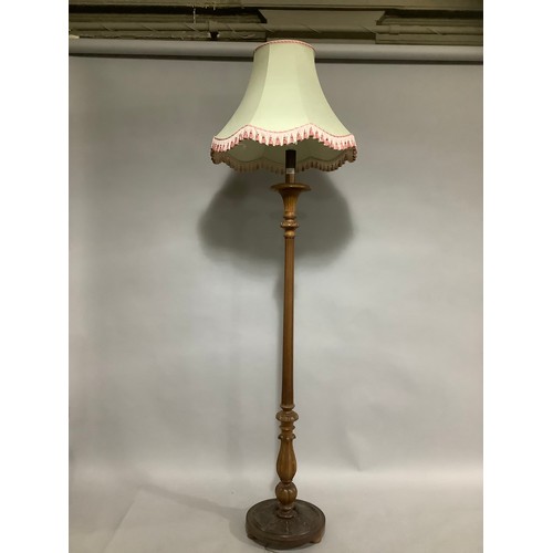 142 - A carved beech standing lamp with shade