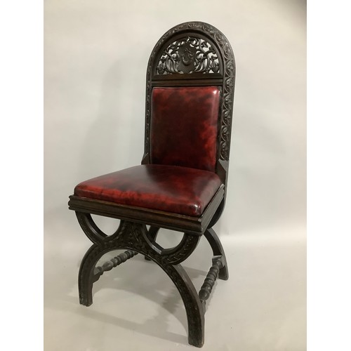 437 - An early 20th century oak gothic style hall chair with pierced and carved back in faux leather uphol... 