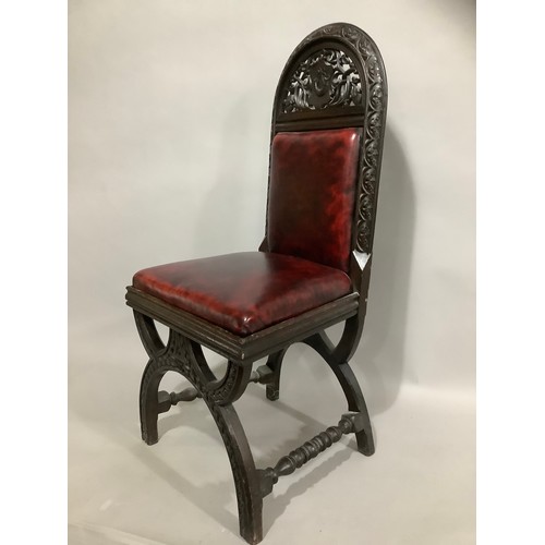 437 - An early 20th century oak gothic style hall chair with pierced and carved back in faux leather uphol... 