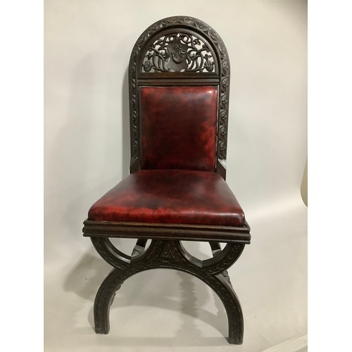 437 - An early 20th century oak gothic style hall chair with pierced and carved back in faux leather uphol... 