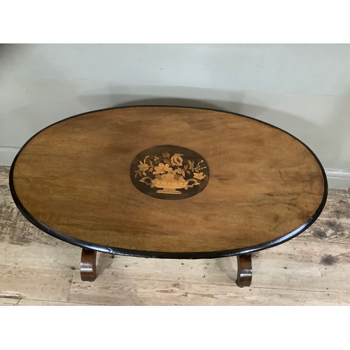 443 - A Victorian mahogany and walnut inlaid oval  window table the centre inlaid with flowers held in an ... 