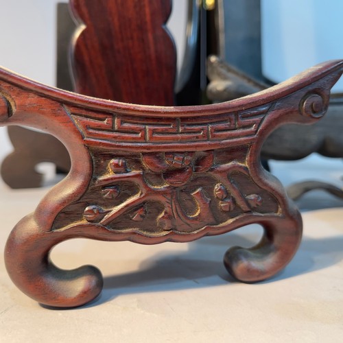 243 - Six Chinese wooden plate stands of pierced, carved and plain design, sizes from 14cm to 34cm high