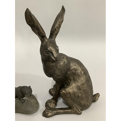 12 - A bronze effect hare by Frith Sculpture, 29cm, together with a model of an otter upon a rock, 17.5cm... 