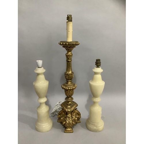 144 - A gilt baroque style table lamp, 57cm high to fitting, together with a pair of alabaster table lamps... 