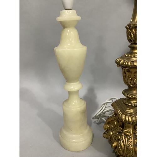 144 - A gilt baroque style table lamp, 57cm high to fitting, together with a pair of alabaster table lamps... 