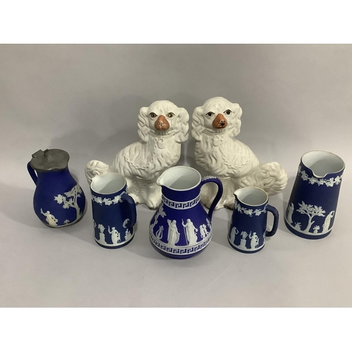 91 - A pair of Staffordshire spaniels with painted features, a set of three Wedgwood Jasper ware jugs of ... 