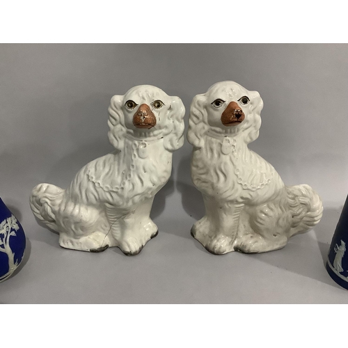 91 - A pair of Staffordshire spaniels with painted features, a set of three Wedgwood Jasper ware jugs of ... 