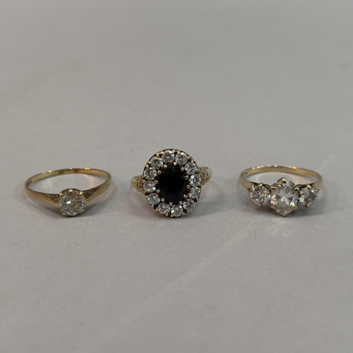 212 - Three dress rings all in 9ct gold, variously set in cubic zirconia and sapphire,
total approximate w... 