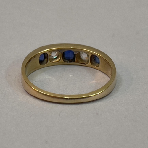 220 - A Victorian Sapphire and diamond five stone ring in 18ct. gold, the graduated oval facetted sapphire... 