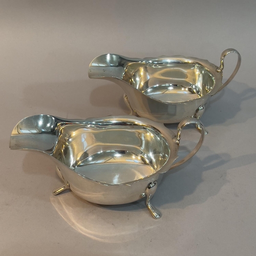 162 - A pair of George V silver sauce boats, Sheffield 1933 for Viners Ltd, each with scalloped rim, on th... 