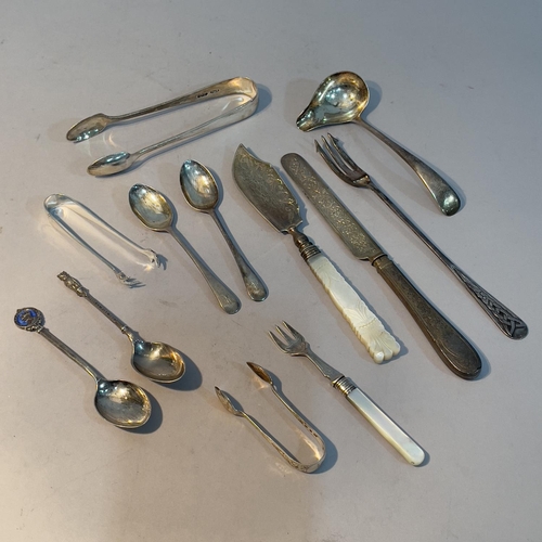 168 - A collection of 19th and early 20th century silver spoons, pickle fork, sugar tongs etc