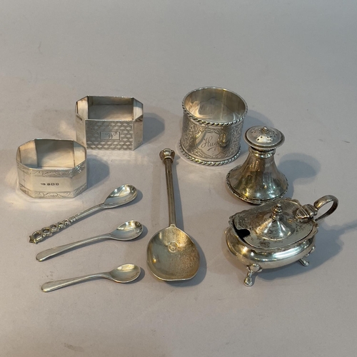 167 - A small collection of silver napkin rings, condiment pieces and a commemorative Queen Elizabeth II s... 