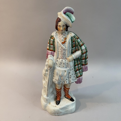 15 - A mid 19th century Staffordshire pottery figure of Robert The Bruce standing wearing a feathered hat... 