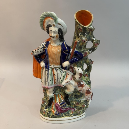 16 - A mid 19th century Staffordshire pottery figural spill vase of a Scottish huntsman and hound, fallen... 