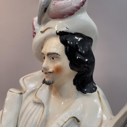 17 - A mid 19th century Staffordshire figure of Will Watch standing with gun and powder horn beside barre... 