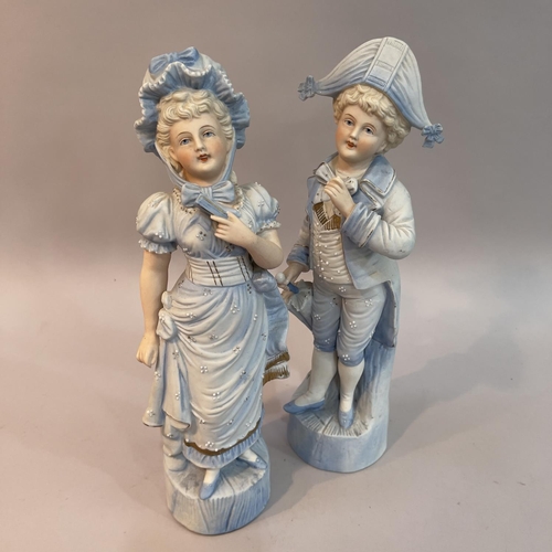 20 - A pair of late 19th century continental pale blue figures of children dressed as a beau and companio... 