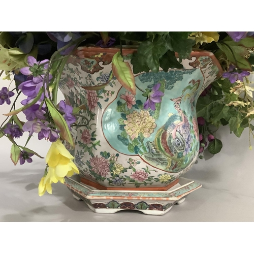 145 - A modern Chinese pottery jardiniere enamelled with exotic bird and peony within a reserve against a ... 