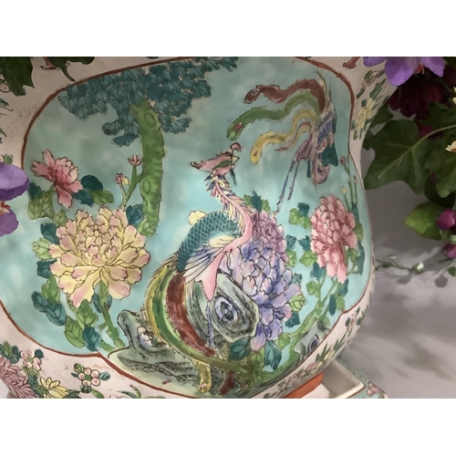 145 - A modern Chinese pottery jardiniere enamelled with exotic bird and peony within a reserve against a ... 