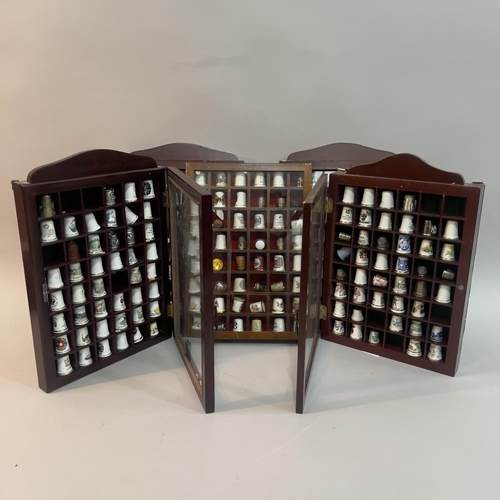 56 - A collection of china thimbles in six glazed cases