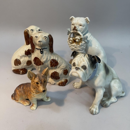 116 - A pair of Staffordshire spaniels 15cm high, a continental bulldog holding a basket of puppies, a Gra... 