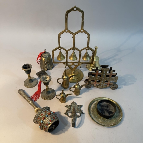 119 - A Chinese bronze Guanshiyin bell, brass meditation bell tree, a Tibetan prayer wheel with cabochons ... 