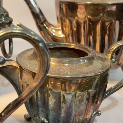 104 - A silver plated tea service comprising teapot, hot water pot, milk jug and cachepot having fluted bo... 