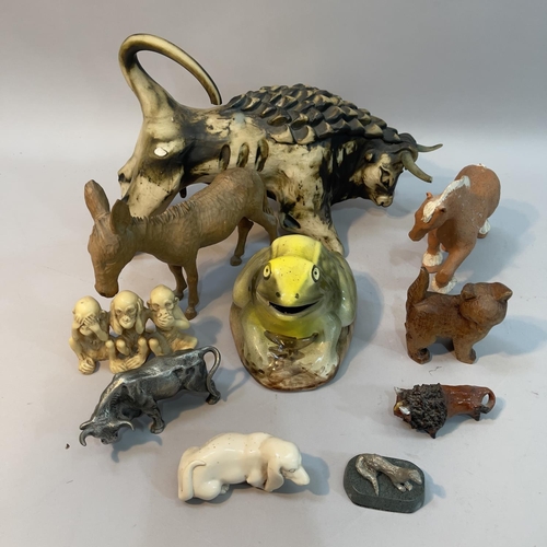 127 - A ceramic figure of a charging bull A/F, a filled pewter bull, a pot figure of a frog together with ... 