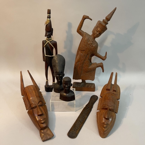 123 - A carved wooden Thai figure of dancing girl, two carved African masks, an African carved tribesman a... 