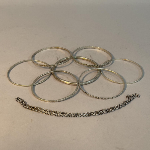 223 - A collection of bangles, three George V silver and four in white metal (tests as silver), together w... 