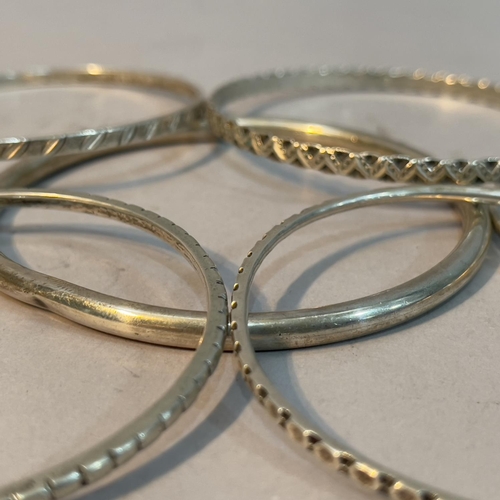 223 - A collection of bangles, three George V silver and four in white metal (tests as silver), together w... 