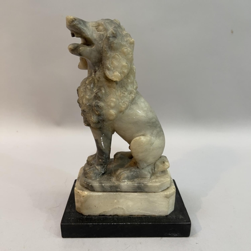 26 - An alabaster carved figure of a poodle, mouth open upon plinth on ebonised base, 19cm high