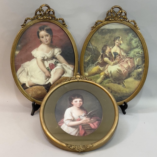 143 - A pair of gilt oval picture frames with ribband creating, overall 45cm x 31.5cm, the glass 36.5cm x ... 