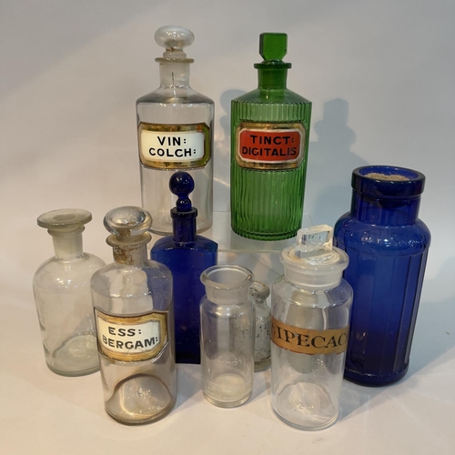 180 - A collection of apothecary bottles comprising a green example Tinct Digitalis, a large clear bottle ... 