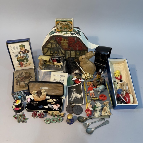 102 - A money tin in the form of a tudor cottage together with a quantity of figurines and ephemera