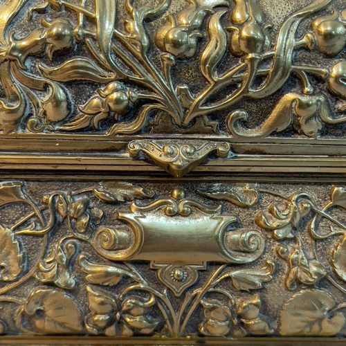 35 - A 19th century ornate brass casket with hinged lid, the body moulded in high relief with thistles, b... 