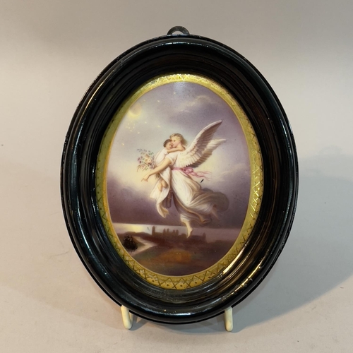 6 - A printed and painted portrait miniature of an angel and child and ebonised frame, overall 14.5cm x ... 