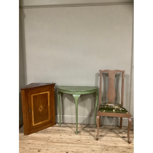 67 - An inlaid hanging corner cupboard, a D shaped green table, a chair with green upholstery