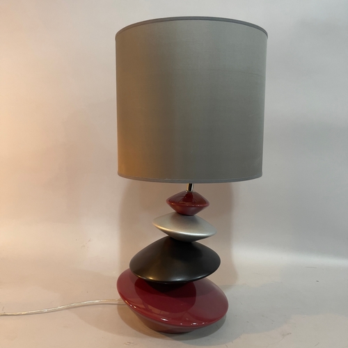 85 - A ceramic pebble tower table lamp in burgundy, black and pewter, with pewter-coloured drum shade, ov... 