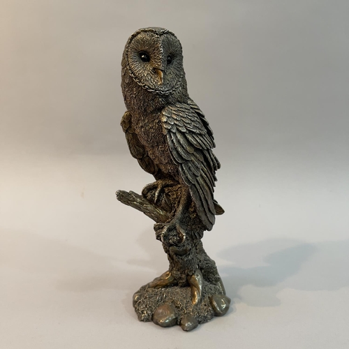 28 - A filled white metal (tests as silver) model of a Barn Owl by Country Artists, modelled on a branch,... 