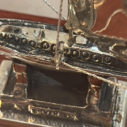 179 - A white metal model of a Greek Yacht in sale with rigging, marked silver 950 and tests as silver, in... 